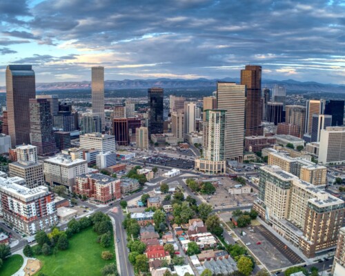 the denver skyline with the rocky mountains in the back