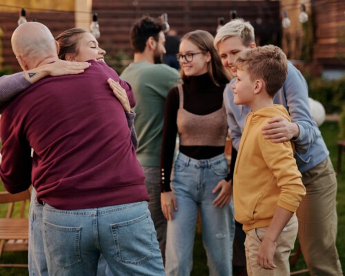 A large family meeting near a house