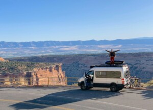 man standing on van outside of Colorado National Monument